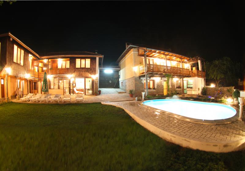 Guest House Ioanna at night — the house and pool lit after dark